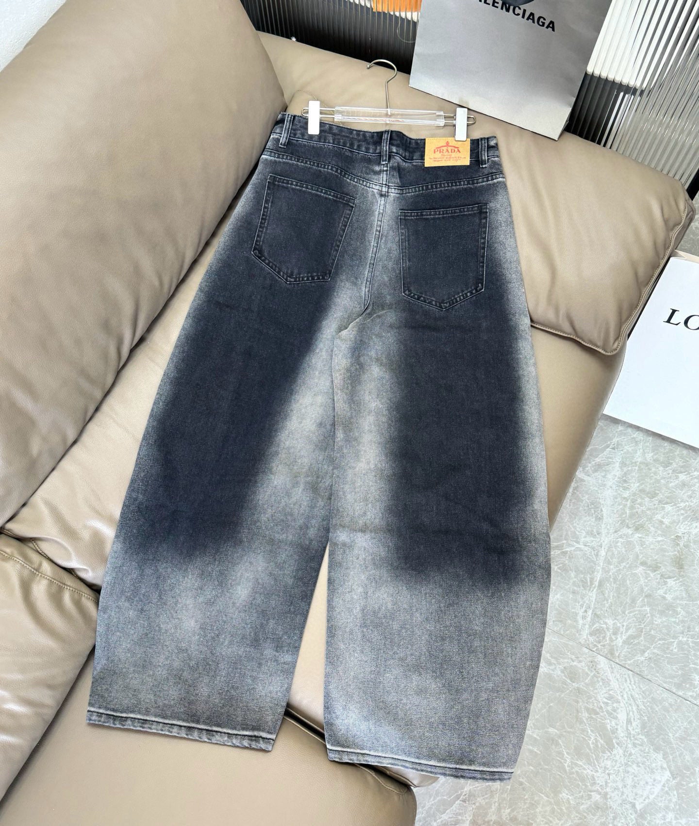 Dark blue denim wide-leg pants with belt loops, button fly, and front pockets