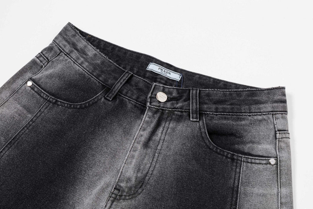 Dark gray denim waistband with button, belt loops, and stitched pockets