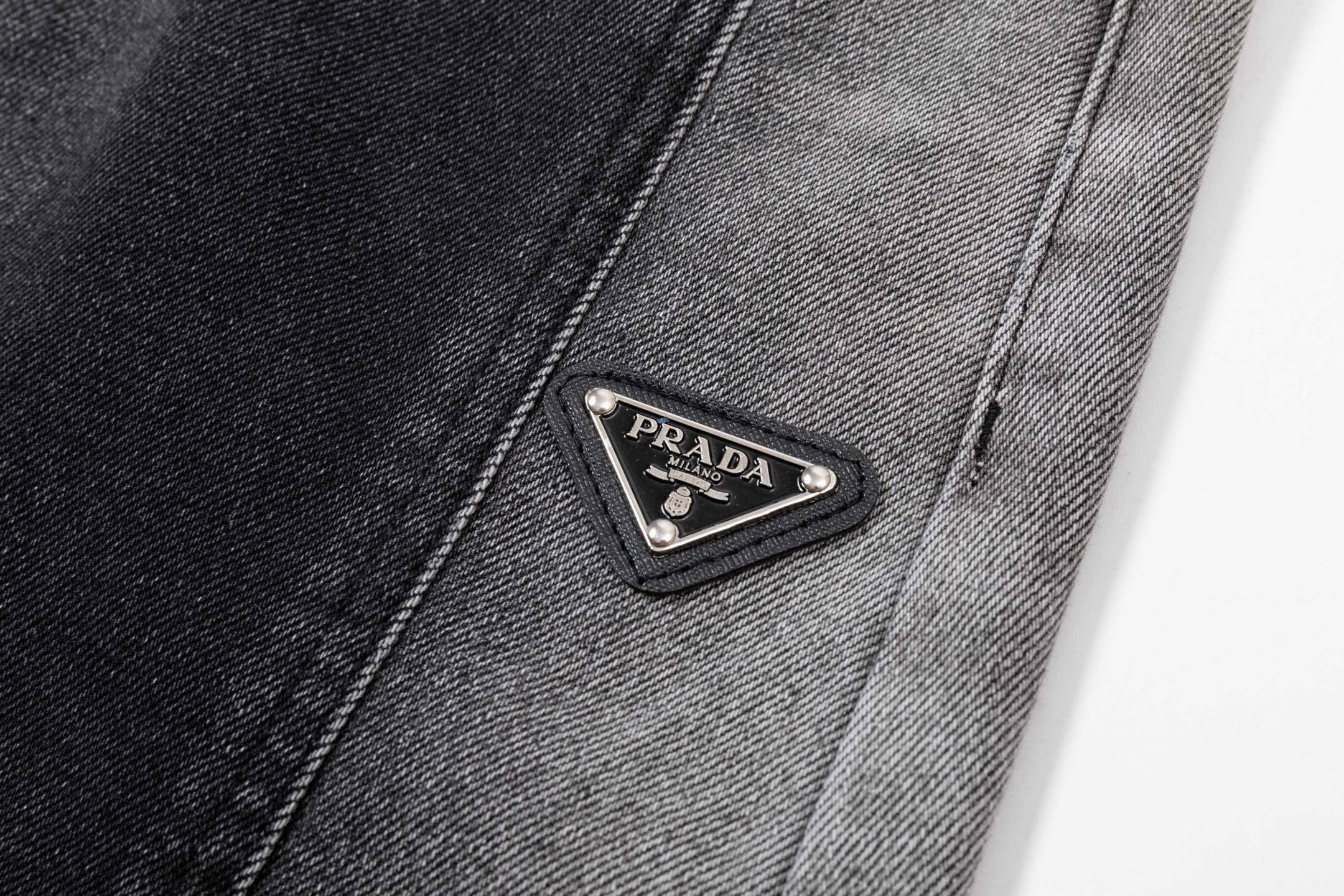 Dark gray denim pants with PRADA triangle leather logo patch