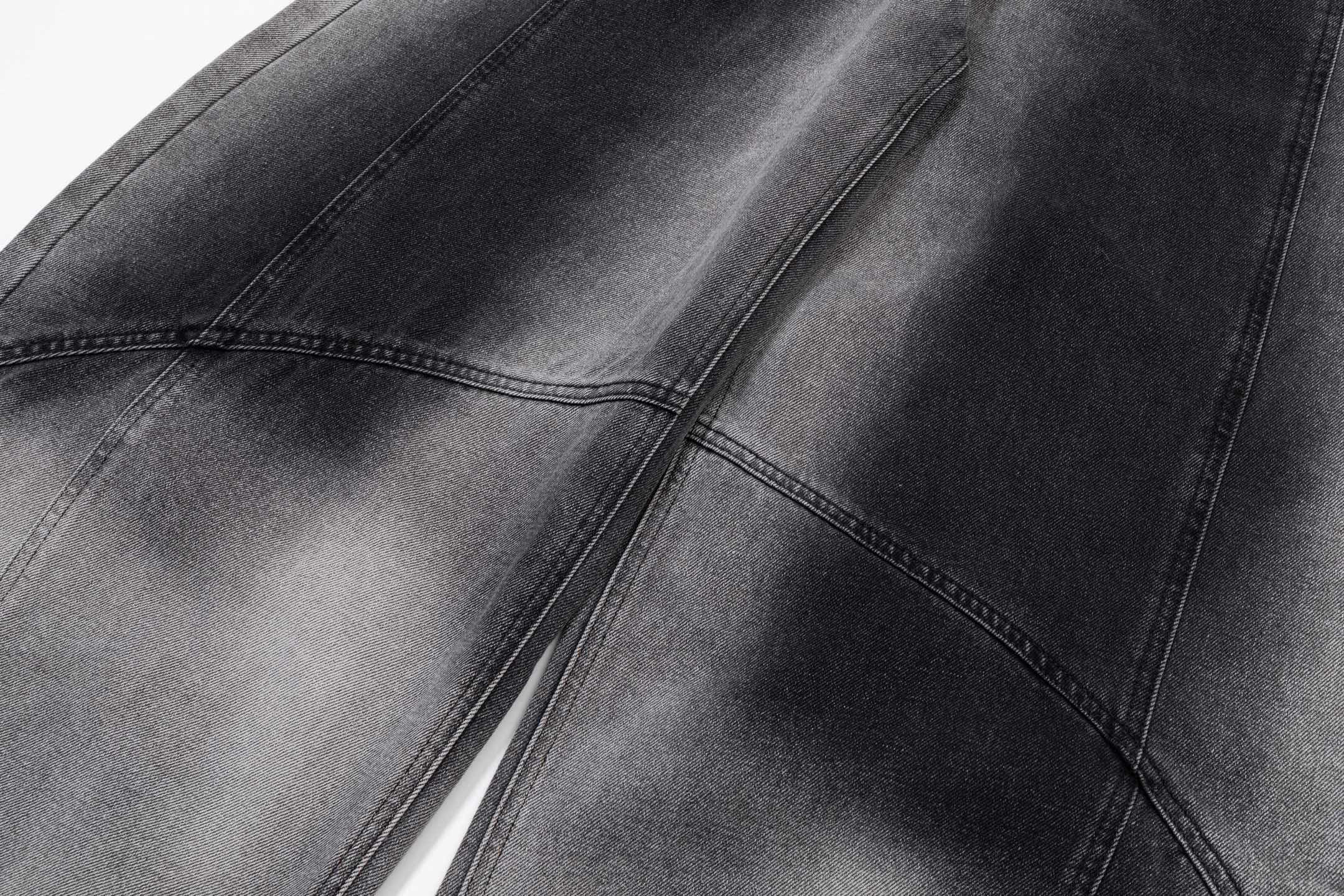 Dark gray denim pants with washed panels and curved side seam