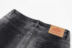 Dark gray denim pants with PRADA leather logo patch at waistband