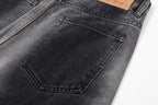 Dark gray denim pants with front patch pocket and stitched seam