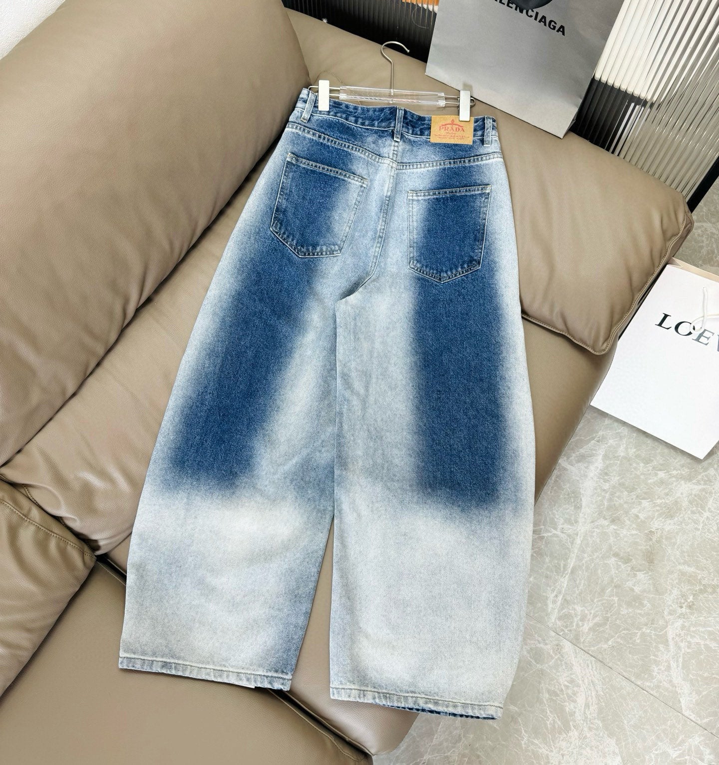 Light blue washed denim pants with relaxed wide leg and front pockets