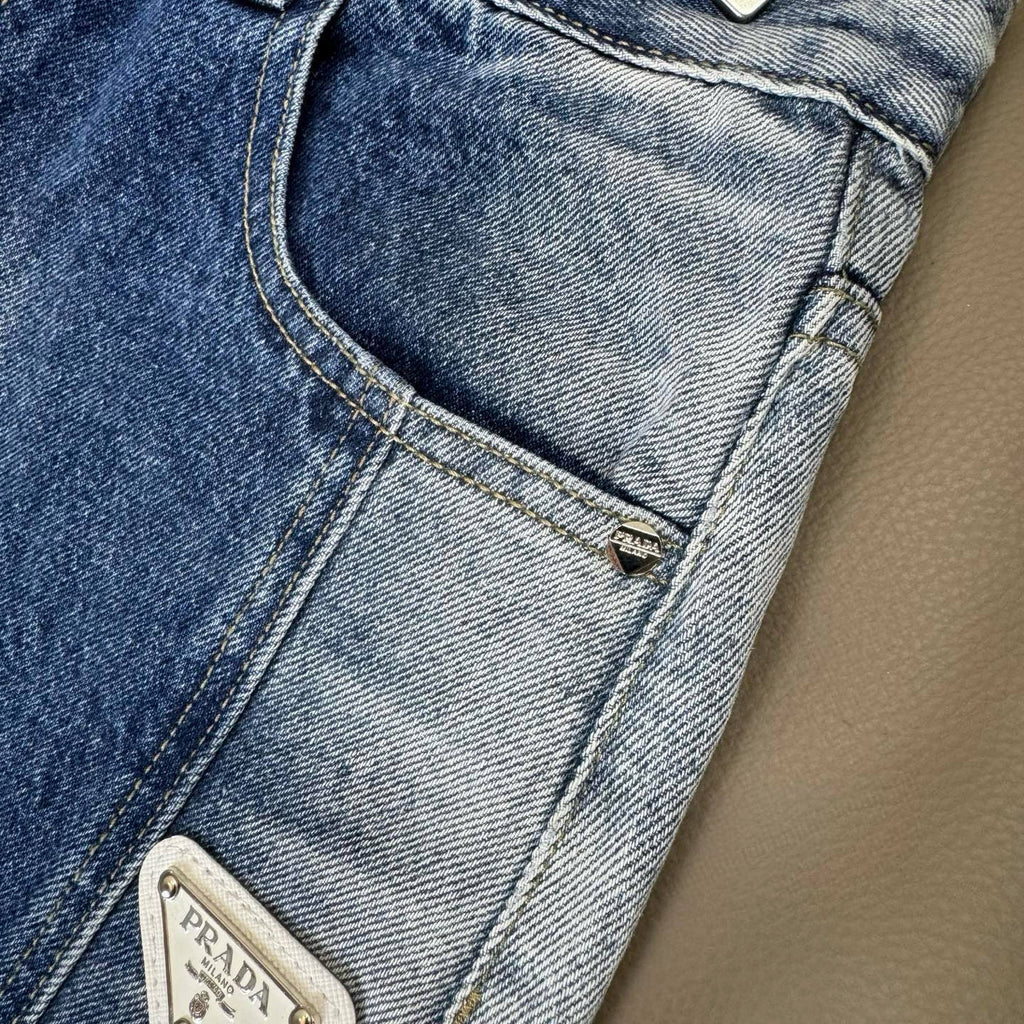 Light blue denim pants close-up of pocket stitching and small logo patch