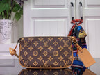Louis Vuitton monogram shoulder bag with tan leather handles and crossbody strap