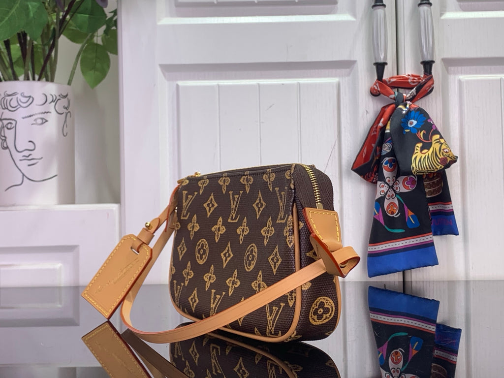 Louis Vuitton monogram crossbody bag with front pocket, tan strap, and gold zipper