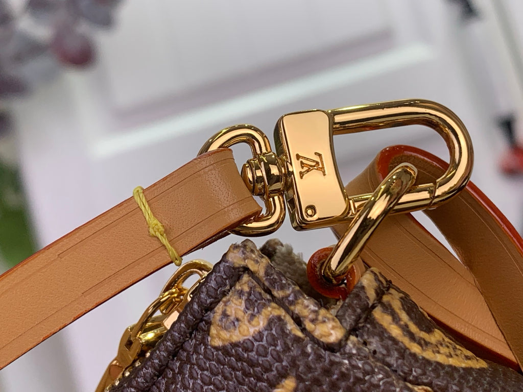 Louis Vuitton tan leather strap with gold clasp on monogram crossbody bag