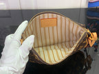 Louis Vuitton monogram bag interior with striped fabric lining and zip closure