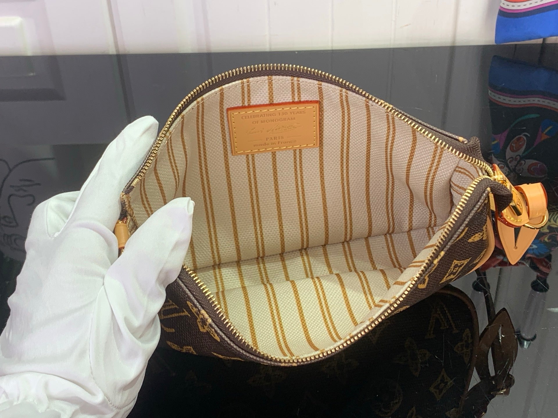 Louis Vuitton monogram bag interior with striped fabric lining and zip closure