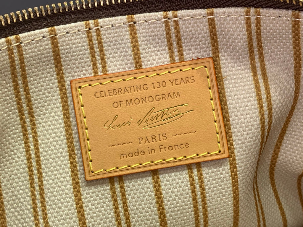 Louis Vuitton monogram bag interior label reading “celebrating 130 years”