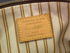 Louis Vuitton monogram bag interior label reading “celebrating 130 years”