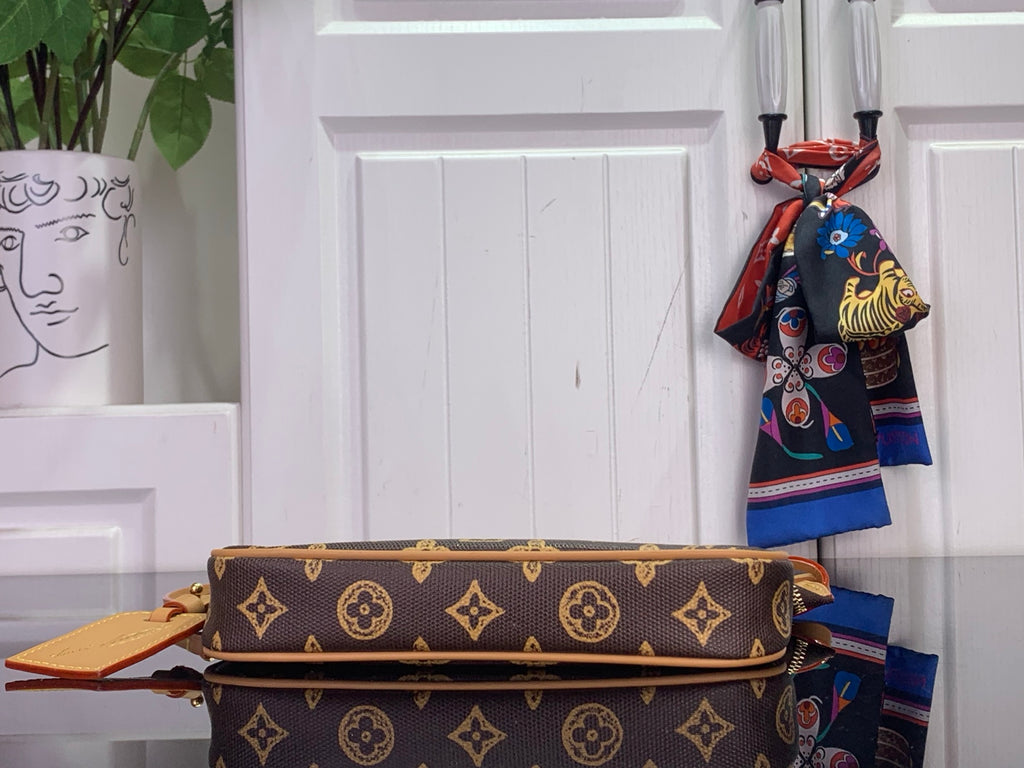 Louis Vuitton monogram shoulder bag with flat top zipper and tan leather trim