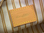 Beige striped bag label with Louis Vuitton signature, gold trim and stitched edges.
