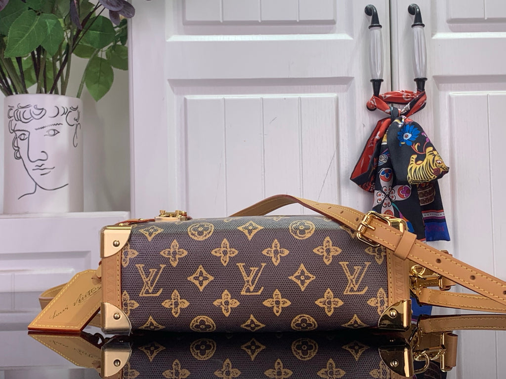 Louis Vuitton monogram handbag with tan straps and gold-tone hardware, side view