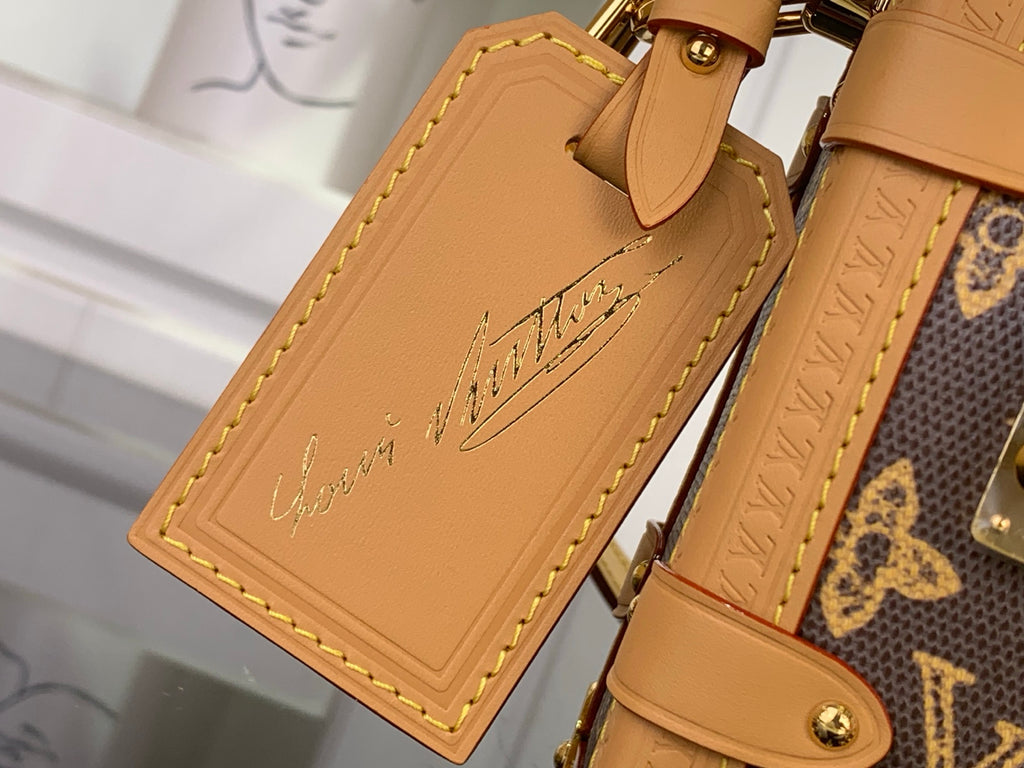 Louis Vuitton tan leather tag with embossed script and yellow edge stitching