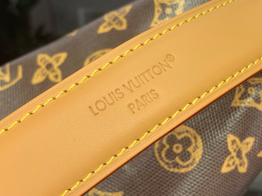 Louis Vuitton leather strap with embossed 'Louis Vuitton Paris' and yellow stitching