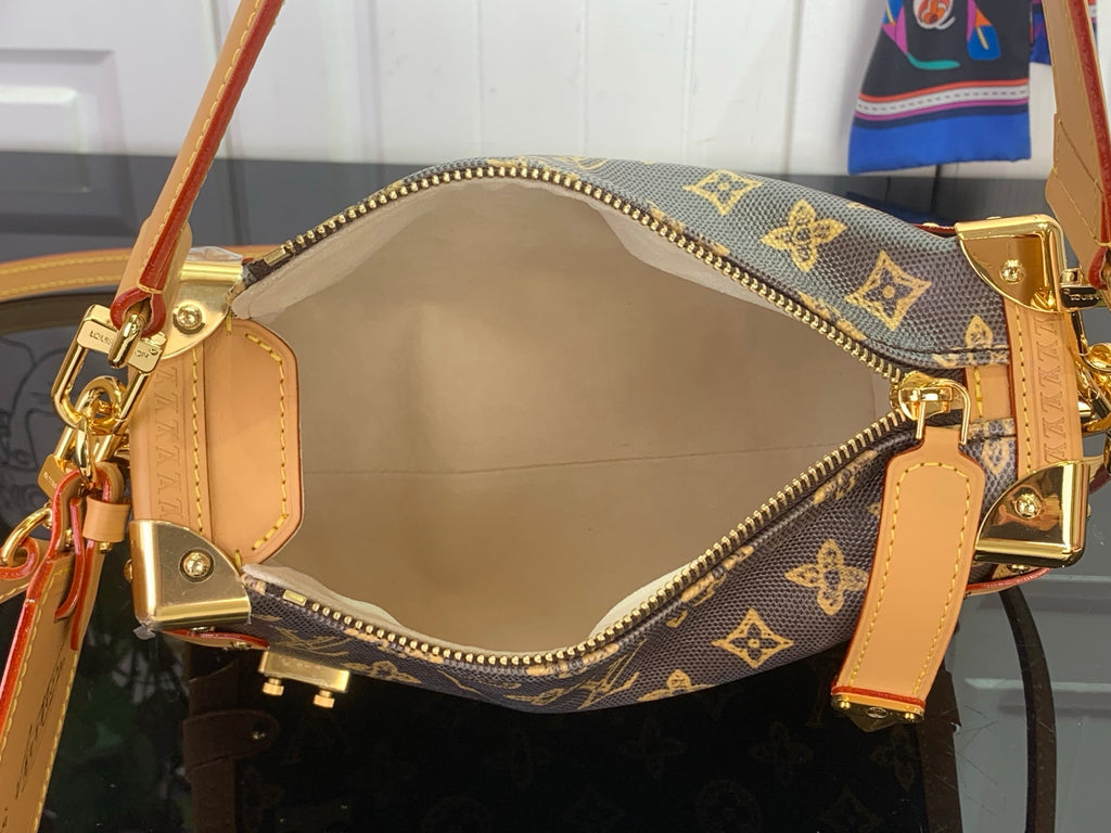Louis Vuitton monogram bag interior with tan lining and gold zipper hardware