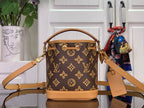 Monogram mini bucket bag with tan crossbody strap and gold-tone hardware