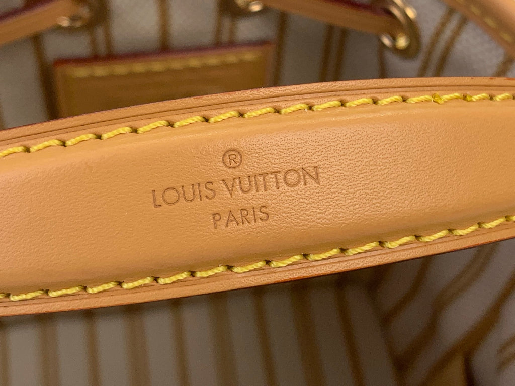 Tan leather bag strap with embossed Louis Vuitton Paris lettering and yellow stitching