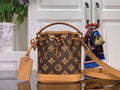 Monogram mini bucket bag with tan leather handles and crossbody strap