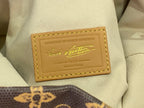 Cream interior label pocket with gold printed branding and stitched leather border