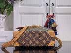 Monogram canvas bucket bag with tan leather straps and gold-tone chain handle