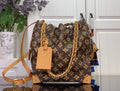 Louis Vuitton monogram canvas bucket bag with tan leather trim and gold chain strap