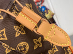 Tan leather strap end with snap closure and stitched detail on monogram canvas