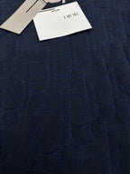 Navy textured knit sweater with Dior hang tags, close-up