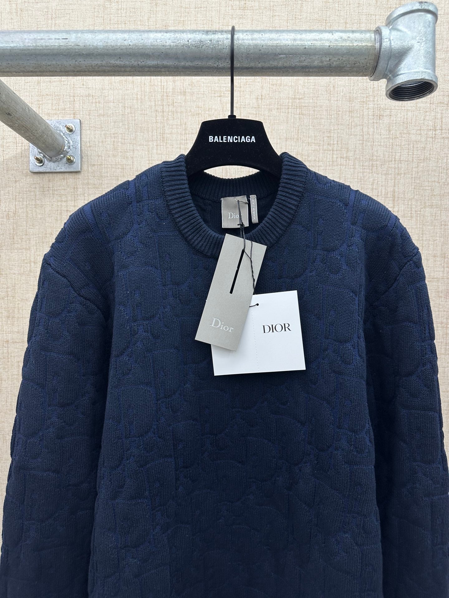 Navy long-sleeve knit sweater with crew neck, hanging Dior tags