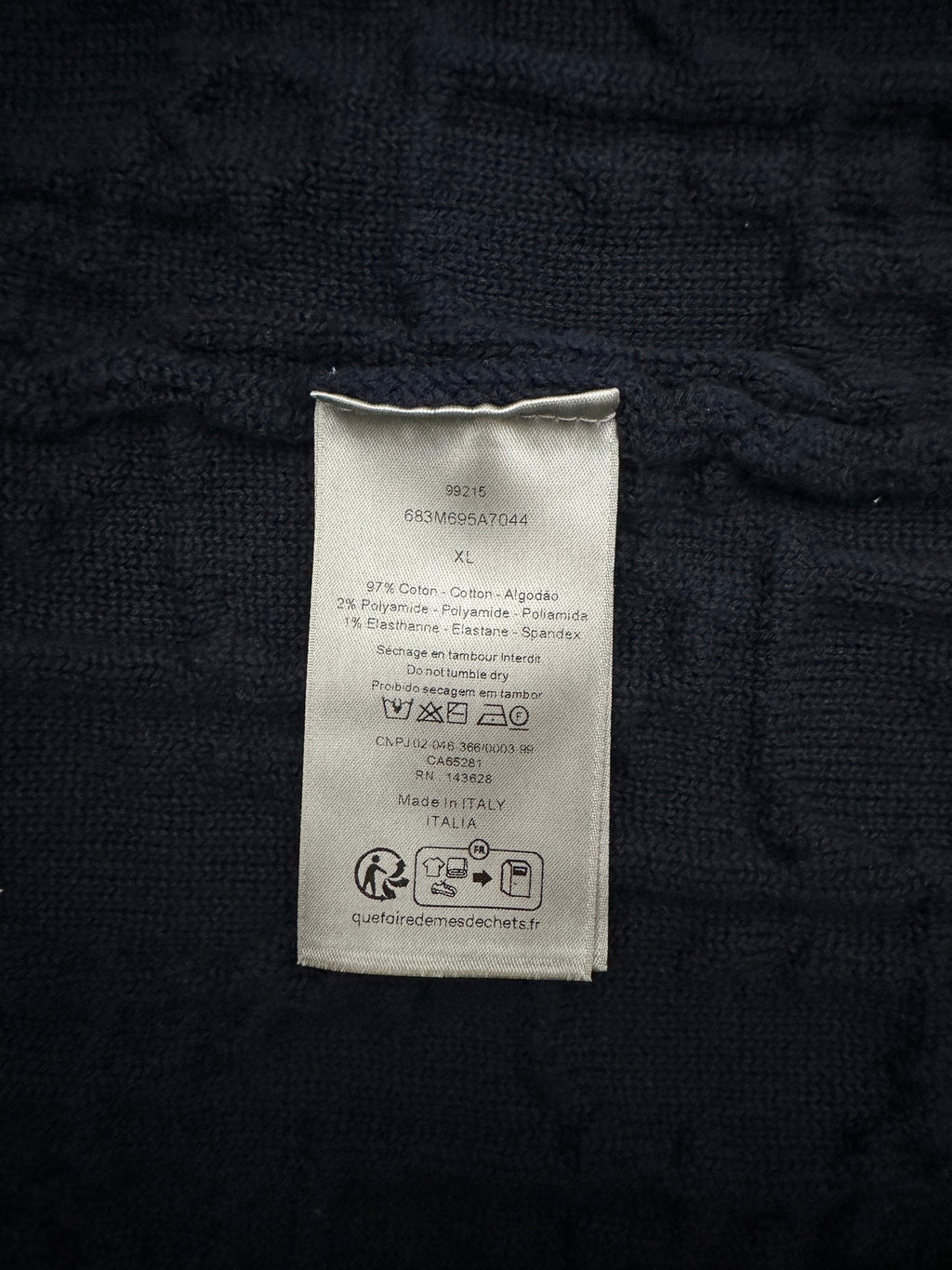 Navy sweater care label patch with printed compliance text