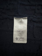 Navy sweater care label patch with printed compliance text