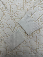 Cream ribbed knit cuffs and sleeves with allover logo pattern
