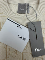 Cream ribbed crew neck sweater with Dior label and hanging retail cards
