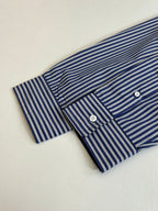 Striped button-up shirt sleeve and chest placket, blue and white vertical stripes