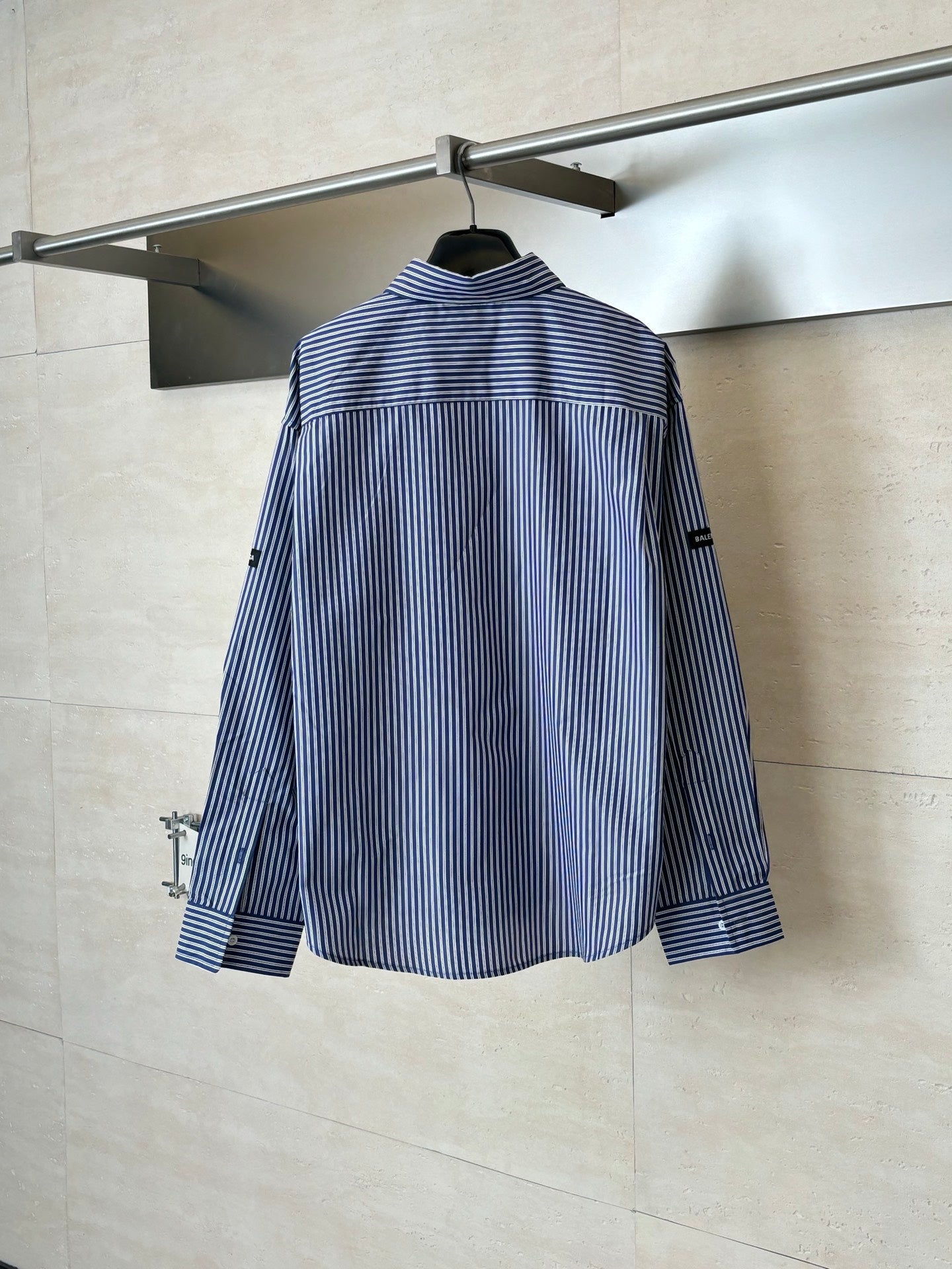 Long-sleeve striped button-up shirt, blue and white vertical stripes, full back view