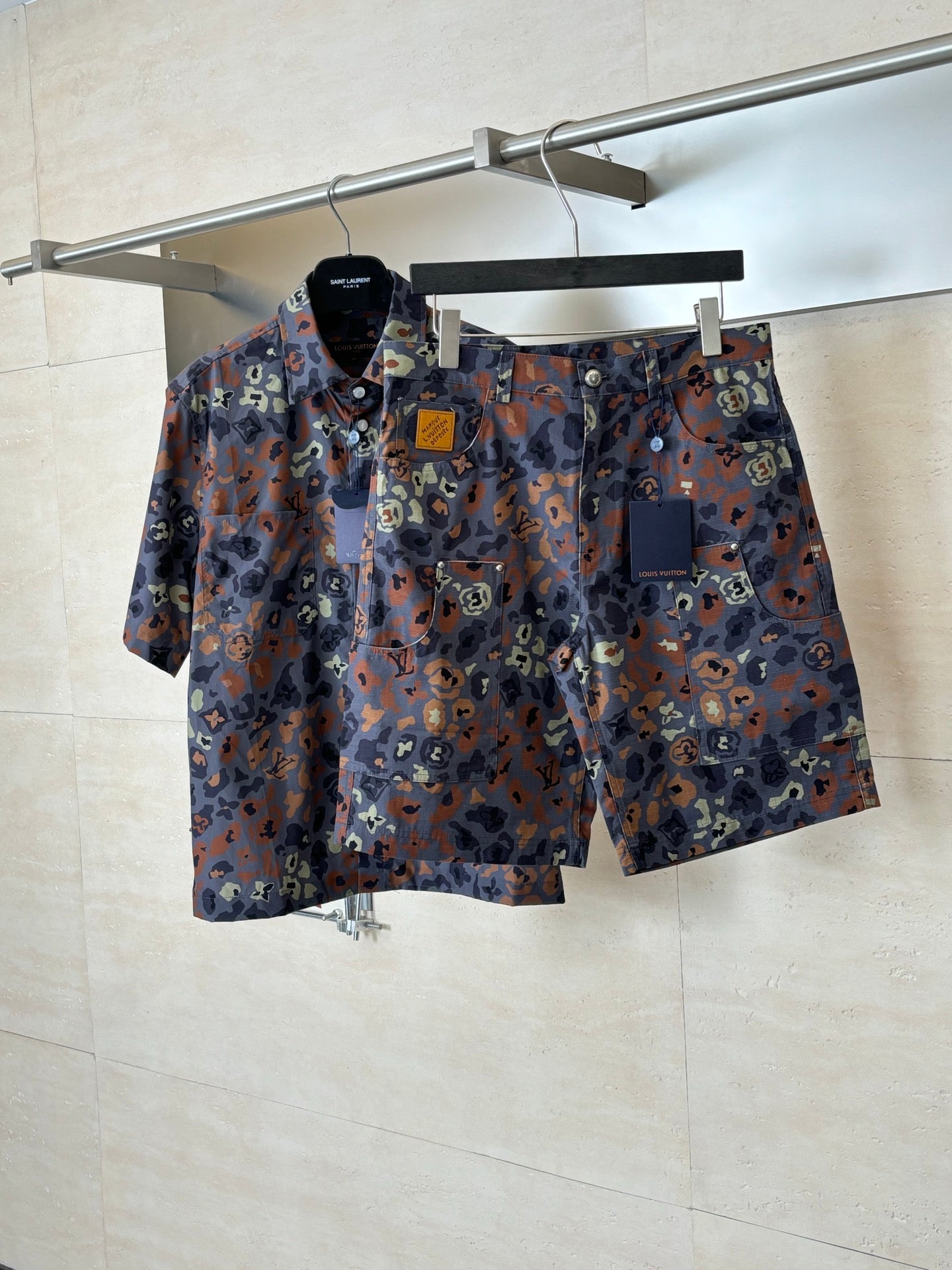 Louis Vuitton patterned shorts on hanger, front pocket openings and button details