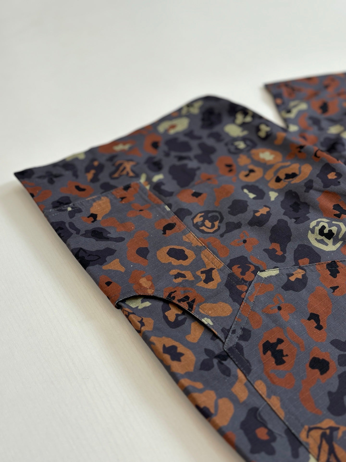 Louis Vuitton pants in dark printed fabric with orange and brown abstract pattern