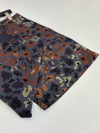 Louis Vuitton patterned shorts laid flat, side angle showing hem and camo print