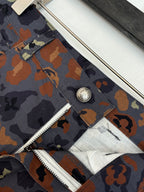Louis Vuitton patterned shorts close-up, metal button and zipper fly seam