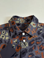 Camo-print shirt collar and front placket with two visible buttons