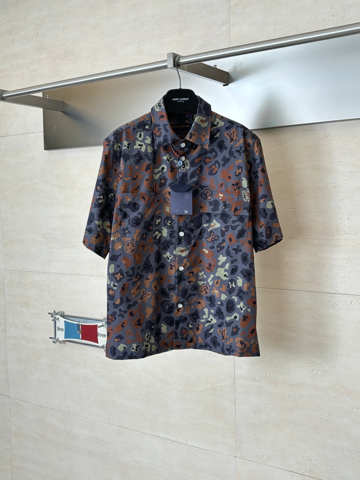 Short-sleeve shirt with multicolor camo pattern and partial button placket