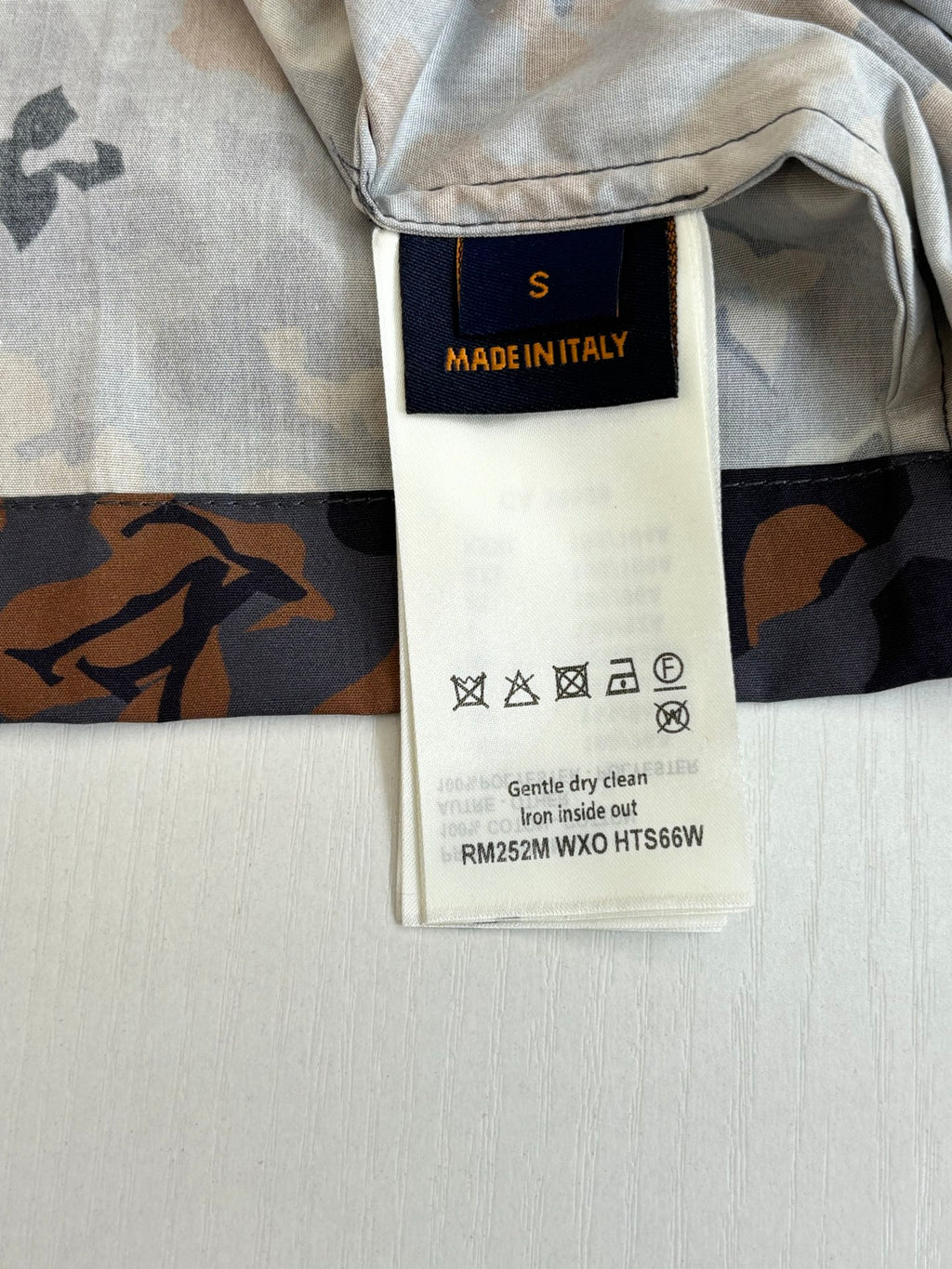 Louis Vuitton shorts interior care label on waistband, light gray with dark print