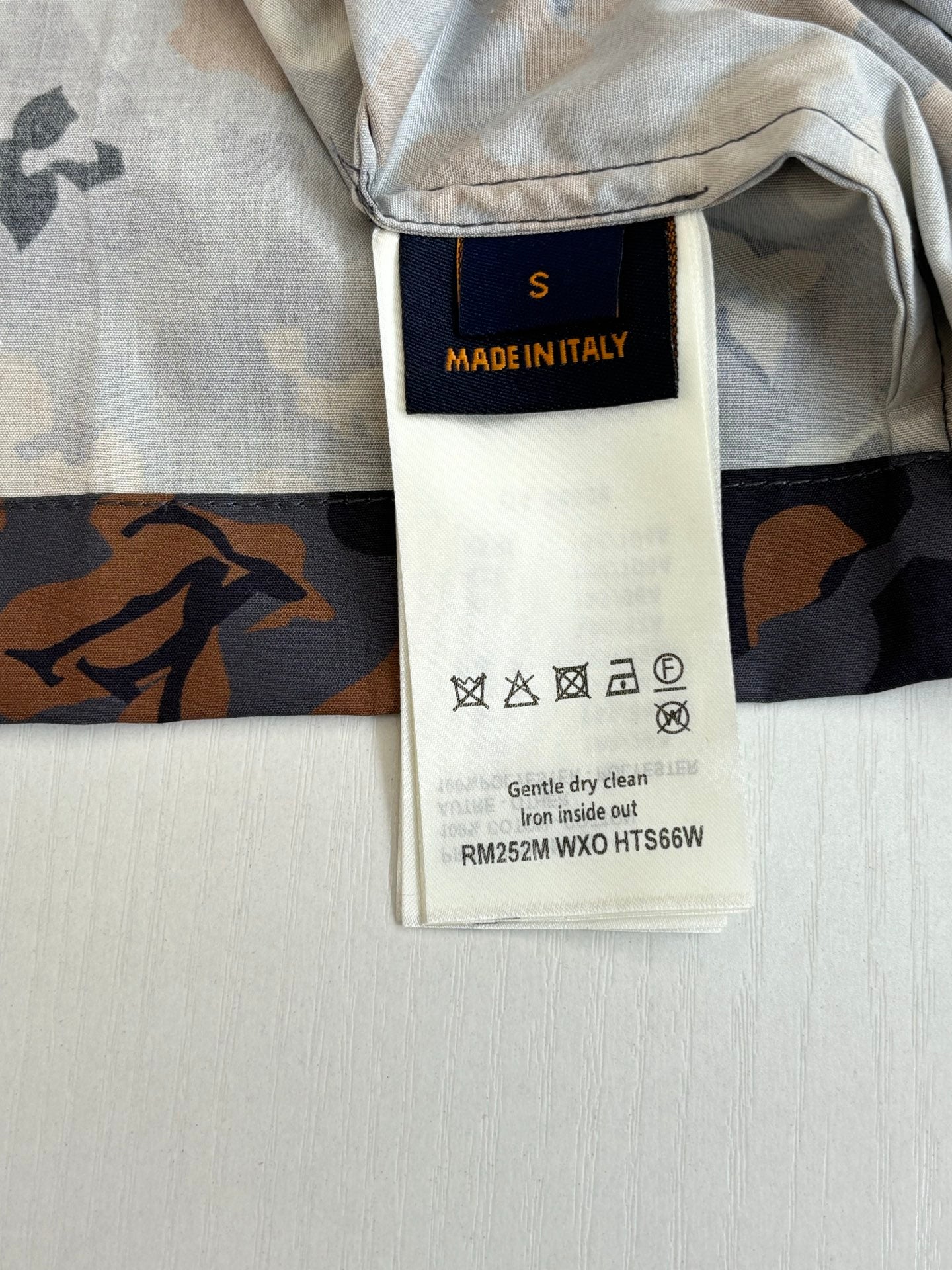 Louis Vuitton shorts interior care label on waistband, light gray with dark print