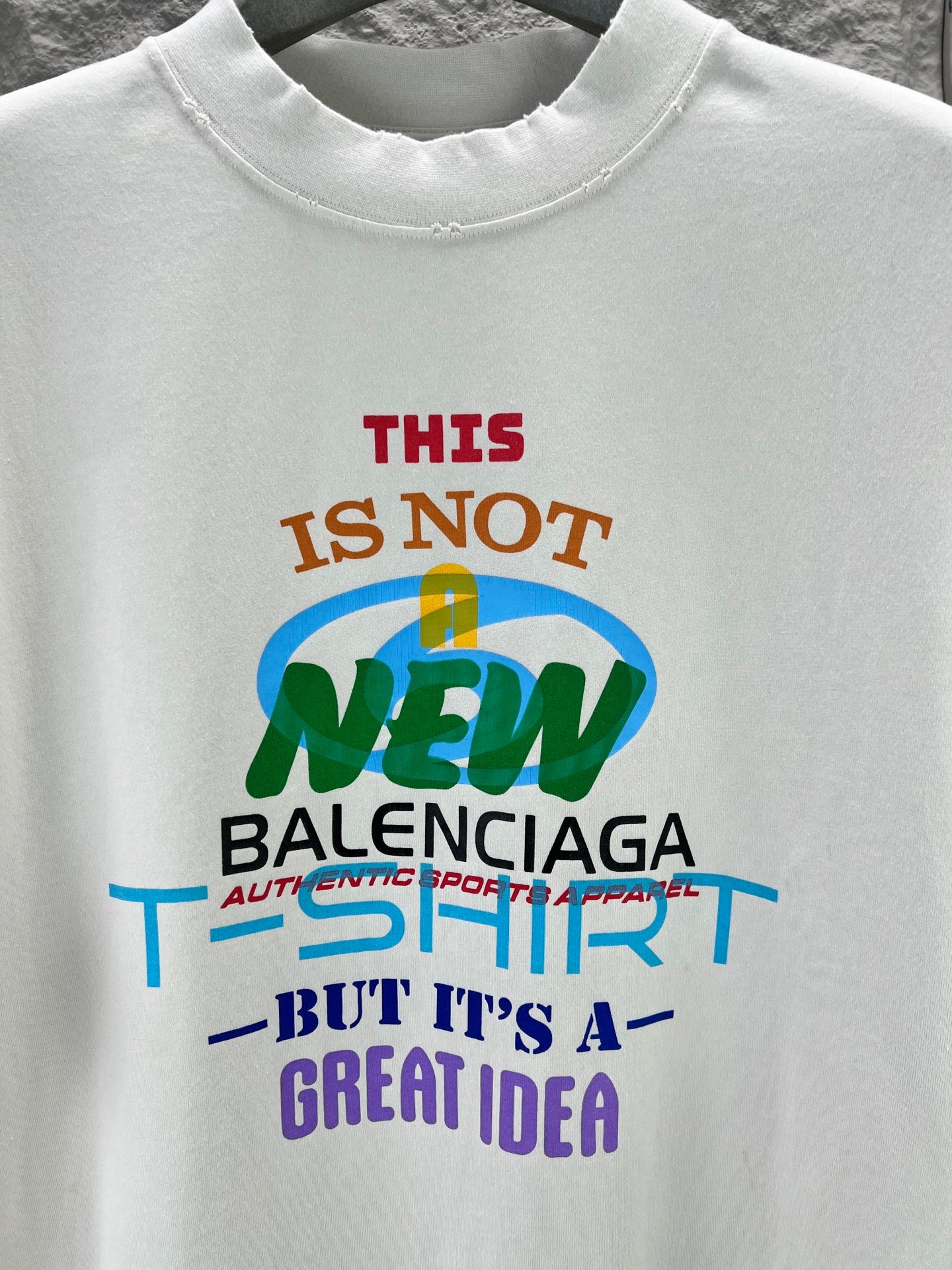Balenciaga T-shirt in white with colorful “THIS IS NOT NEW” front graphic close-up