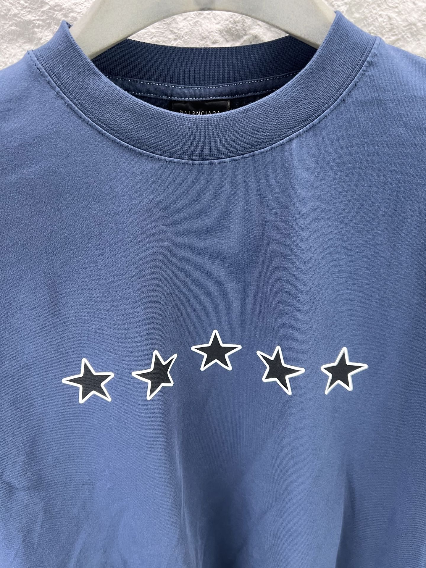 Blue short-sleeve T-shirt with crew neck and five-star row graphic