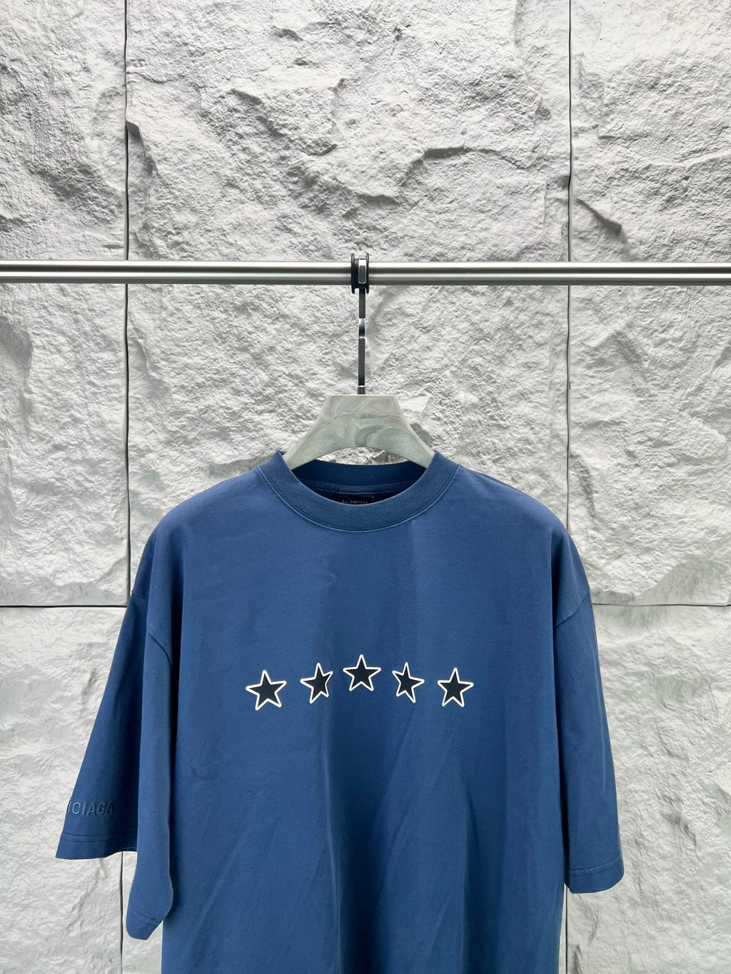 Blue short-sleeve T-shirt with star graphic across the front