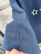 Blue T-shirt sleeve with 'BALENCIAGA' text embroidered on the cuff