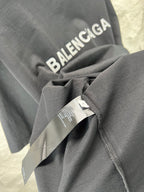 Balenciaga heather gray T-shirt sleeve with attached tag and folded fabric