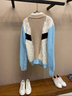 Louis Vuitton long-sleeve knit sweater, striped chevron back in cream, black, and blue